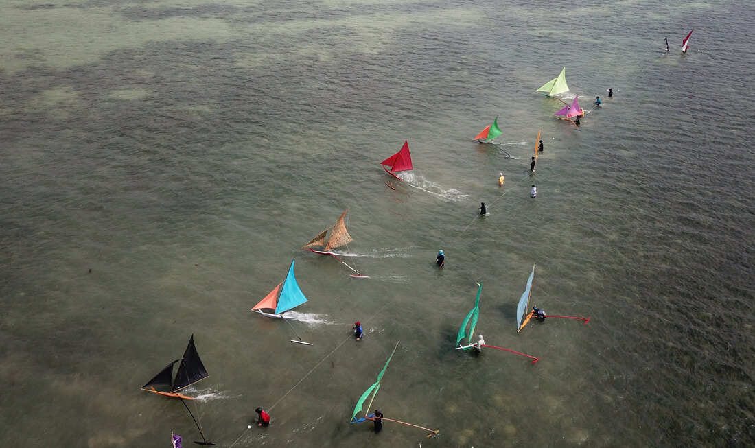 A fleet of jongs racing off Teluk Bakau, Bintan