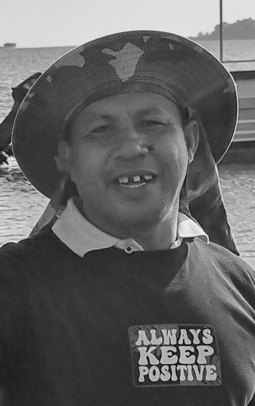 Black-and-white portrait of the man in the “Always Keep Positive” shirt